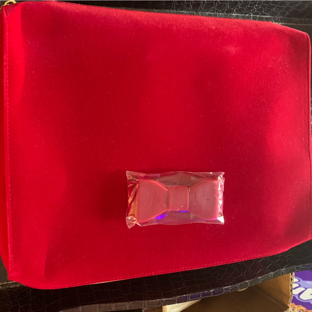 Red plush velvet makeup bag with bonus eye makeup remover.